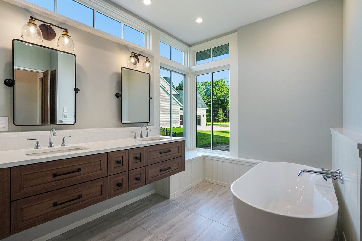 Luxurious bathroom with a freestanding tub and double vanity, part of a custom home by R Value Homes in West Michigan