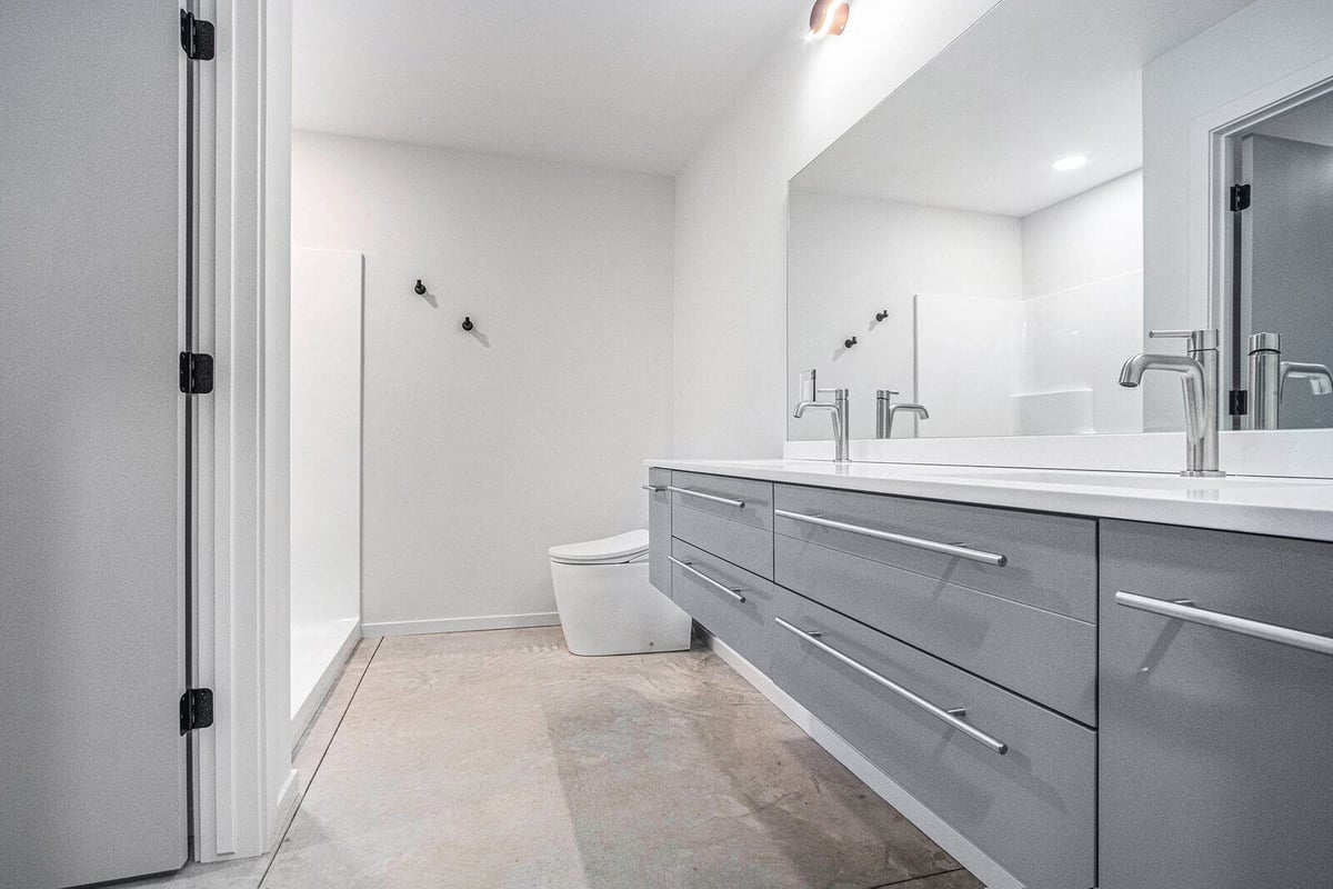 Contemporary bathroom with double vanity and modern fixtures, built by R Value Homes in West Michigan