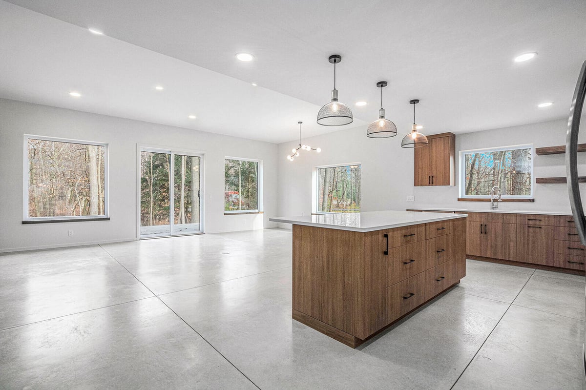 Open-concept kitchen and dining area in a modern West Michigan custom home by R Value Homes