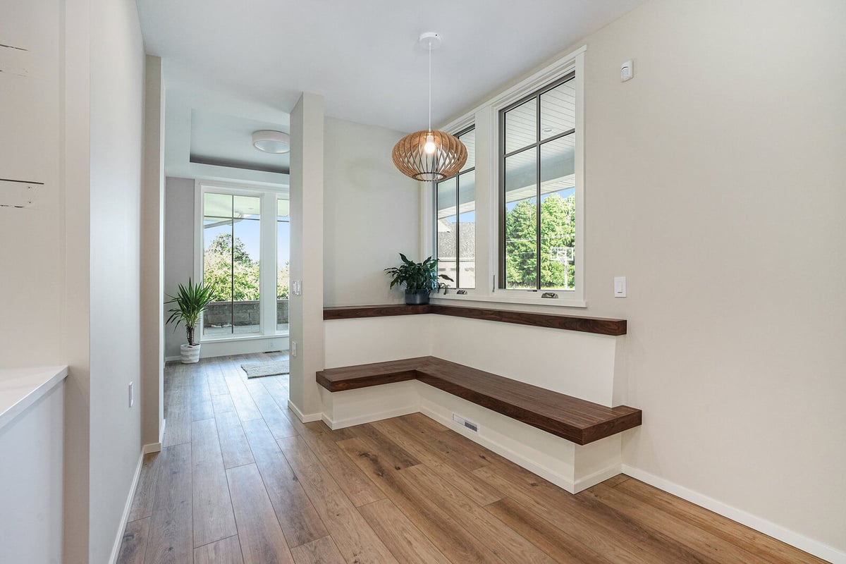 Cozy built-in nook with wood bench and natural light, part of a West Michigan custom home by R Value Homes