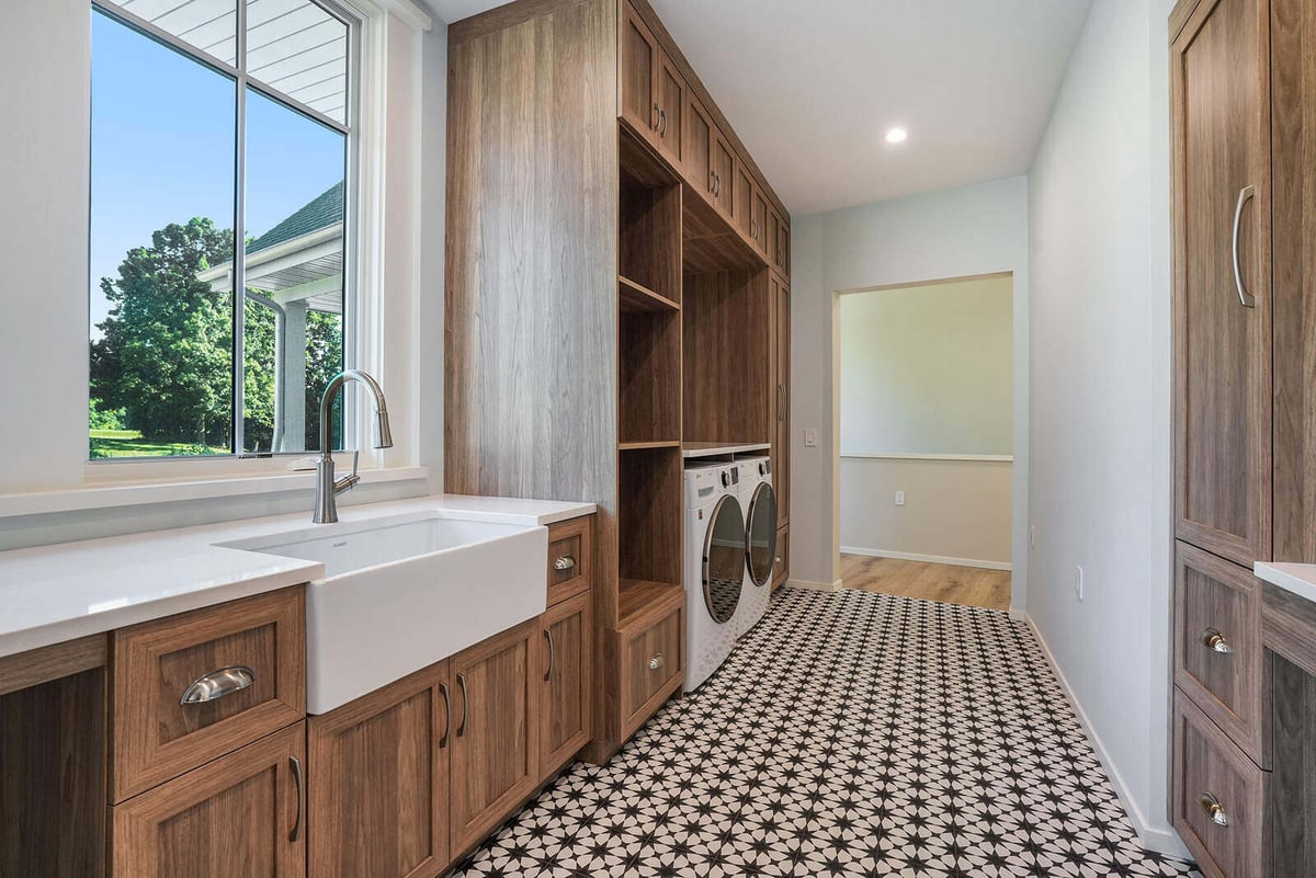 Laundry room with farmhouse sink and built-in cabinetry, part of a West Michigan custom home by R Value Homes