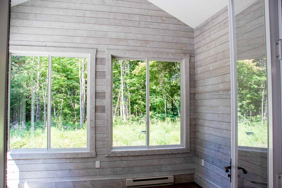 Sunroom in a custom-built home by R-Value Homes in West Michigan, featuring large windows and shiplap walls