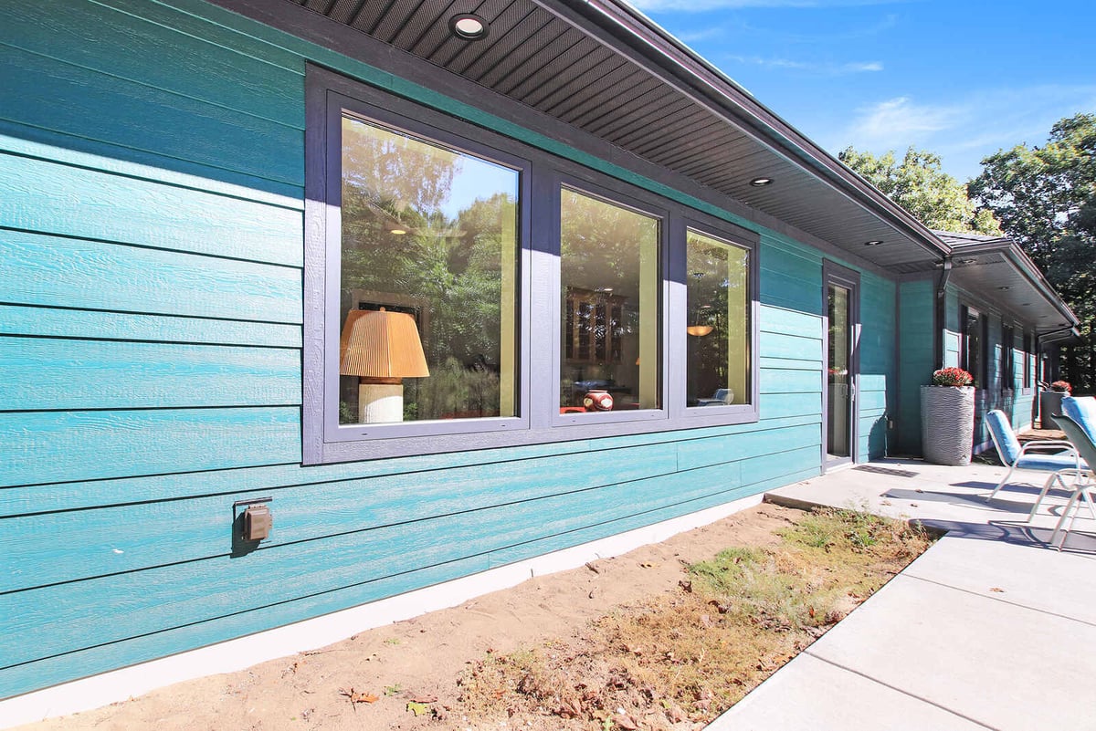 Close-up of the exterior siding and large windows of a custom West Michigan home by R Value Homes