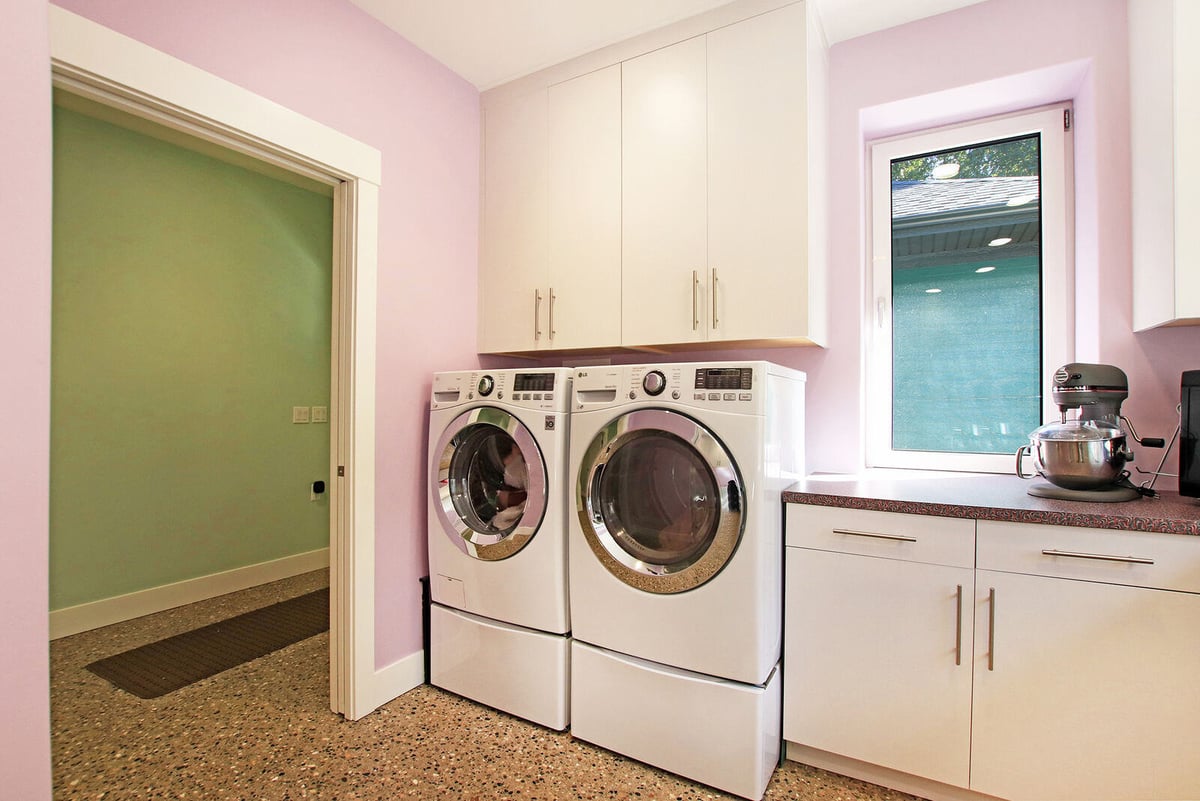 Laundry room in a custom West Michigan home by R Value Homes, featuring modern appliances and pastel-colored walls
