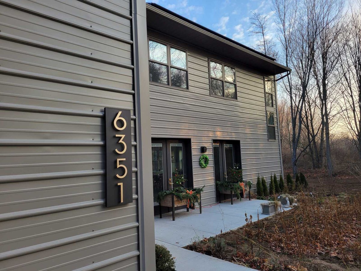 Close-up of a house number sign on the exterior of a custom-built West Michigan home by R Value Homes