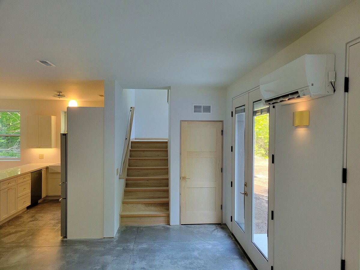 Modern interior staircase and open space design in a custom-built West Michigan home by R Value Homes