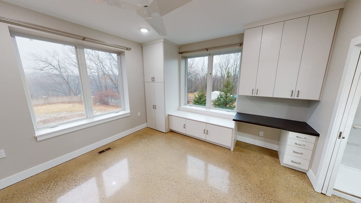 Bright bedroom with built-in cabinetry and large windows, part of a custom home by R Value Homes in West Michigan