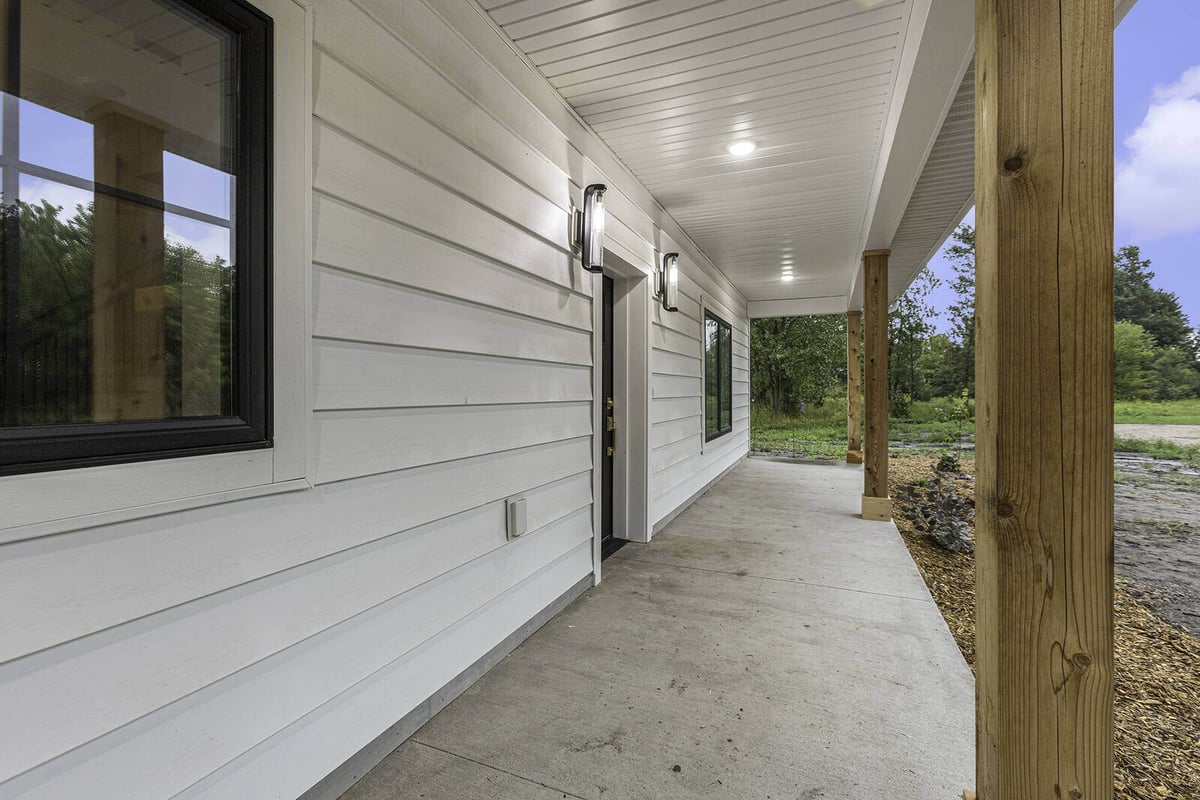 Covered front porch of a modern home by R-Value Homes in West Michigan
