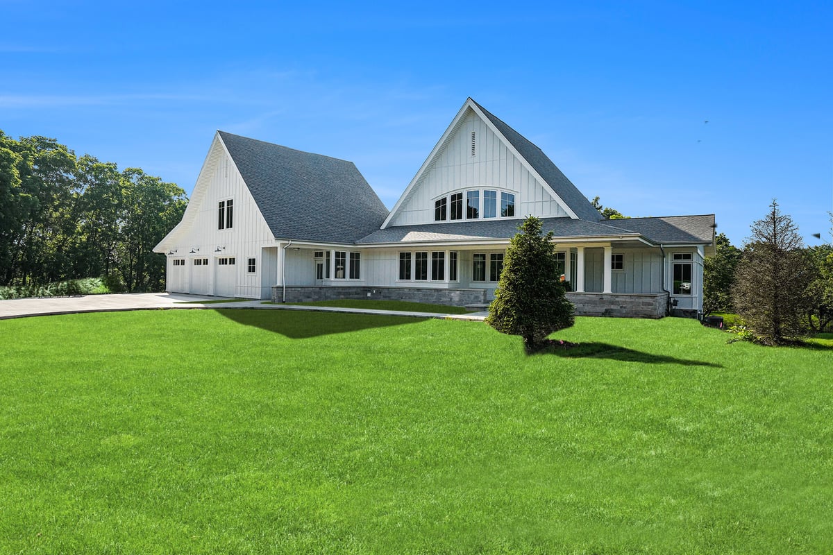 Front view of a modern custum home with green lawn, custom-built by R Value Homes in West Michigan